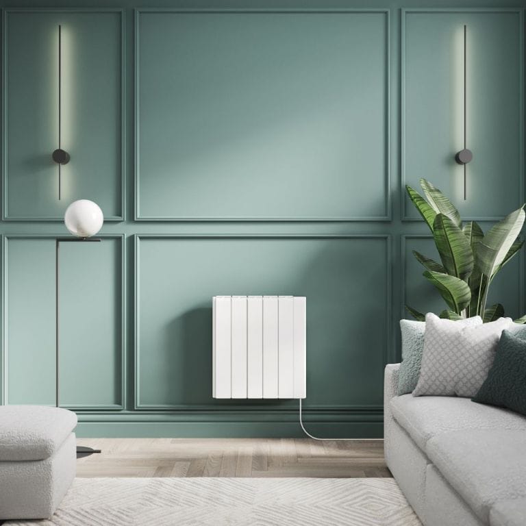 ECOSO Tuc white ceramic core smart electric heater on green wall nearby large houseplant and light grey settee