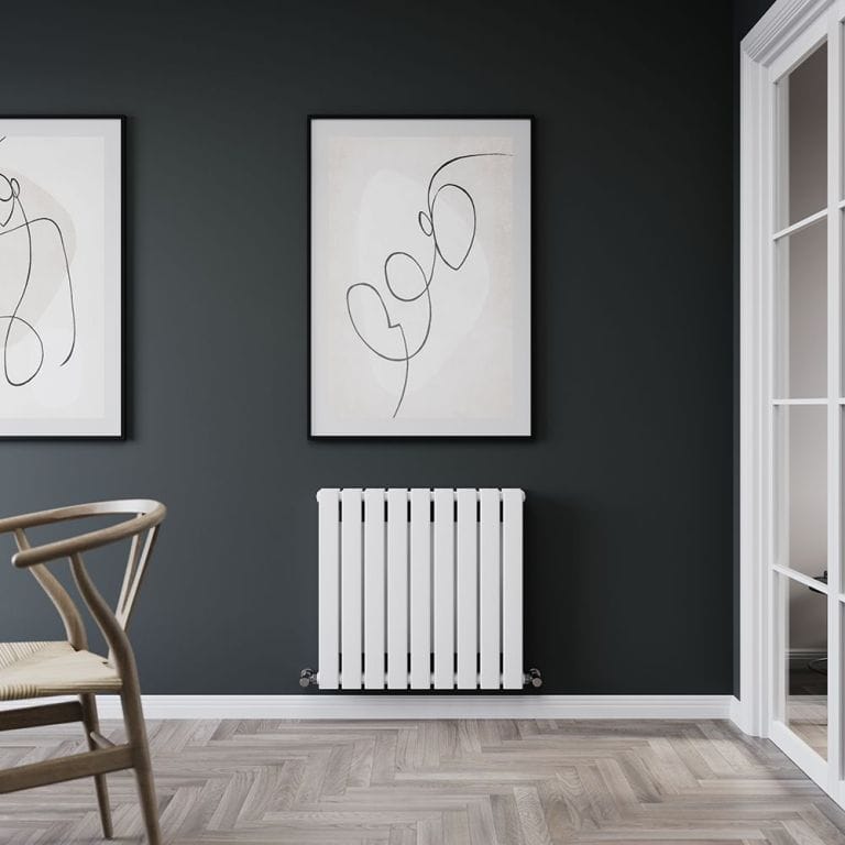 Milano Erin white flat double panel horizontal designer convector radiator on dark wall beneath framed black and white artwork nearby white framed door