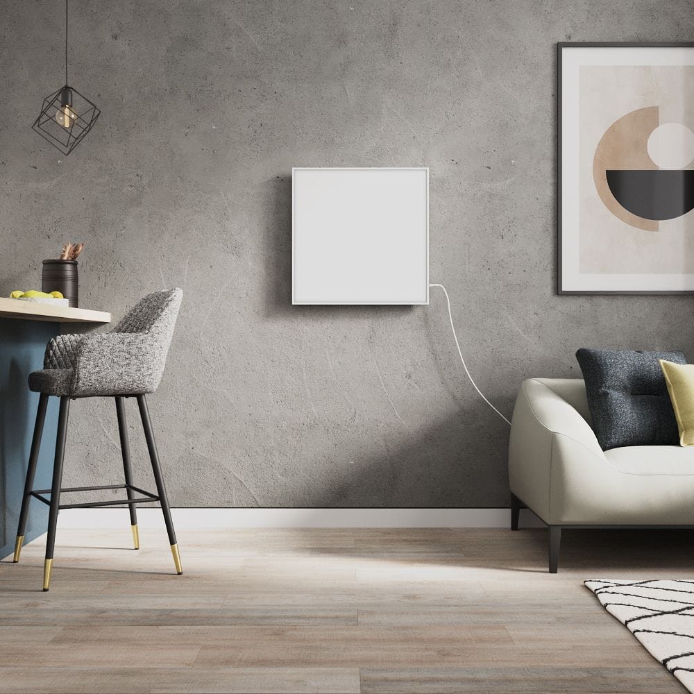 Milano Far white framed plug in smart electric infrared panel heater on grey wall in modern interior near countertop with grey chair and cream settee beneath artwork