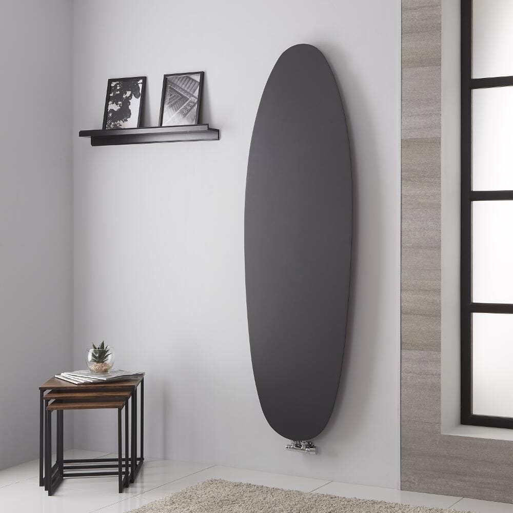 Lazzarini Way Tavolara anthracite vertical designer radiator on light wall in modern interior nearby small table with houseplant and a black shelf with artwork