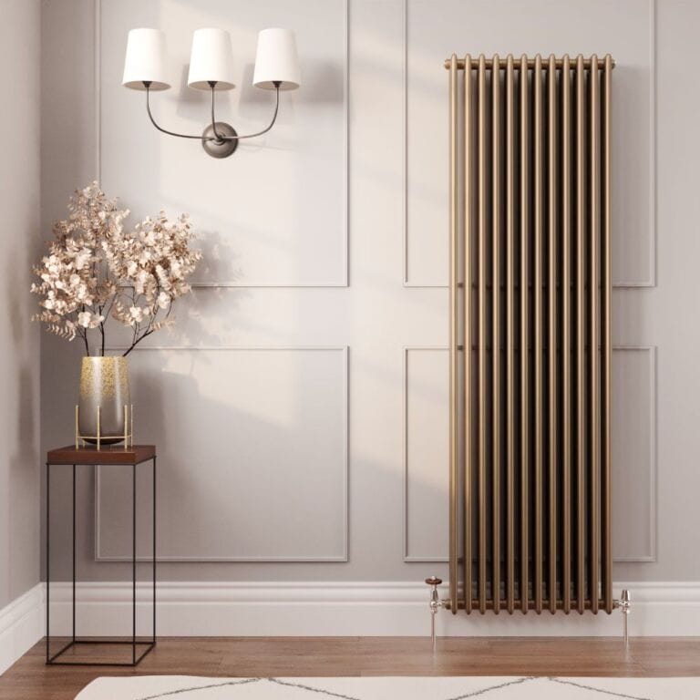 Milano Windsor metallic bronze vertical traditional column radiator on light wall nearby table with gold vase beneath triple light fitting