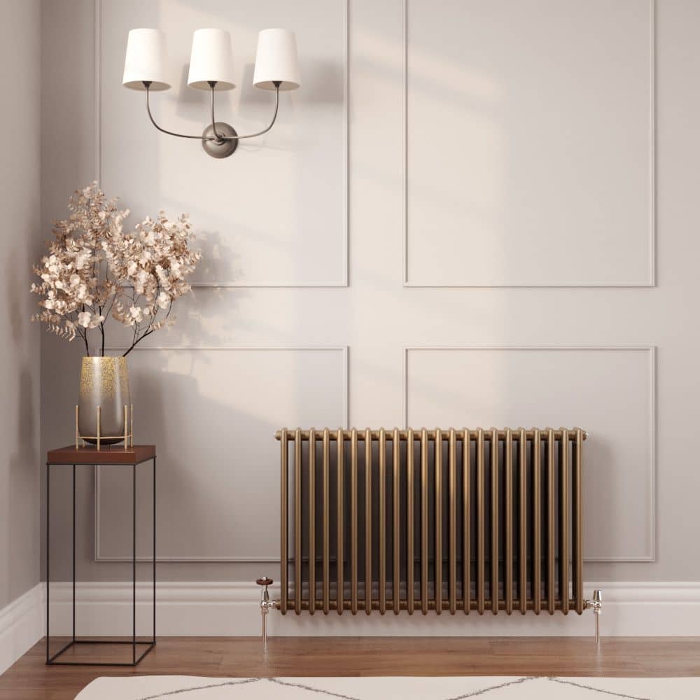 Milano Windsor horizontal traditional metallic bronze triple column radiator on a panelld living room wall