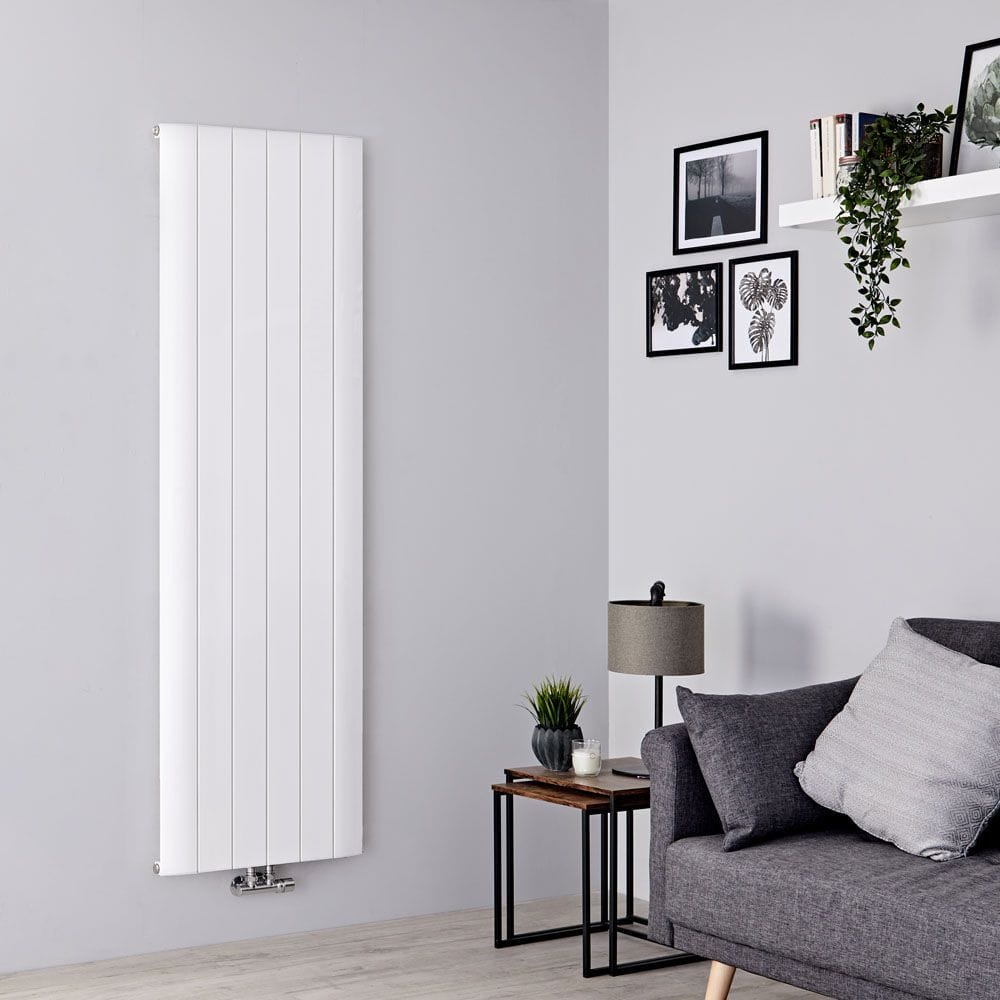 Milano Skye white aluminium vertical designer radiator on light grey wall nearby grey settee under shelf