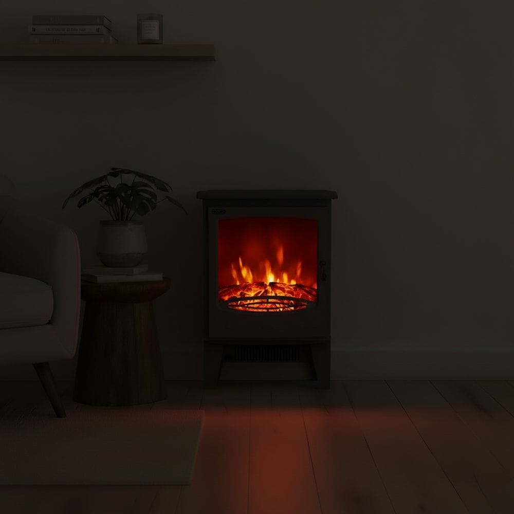 ECOSO Glow black traditional electric stove in dark room nearby houseplant on small table beneath shelf with books and candle