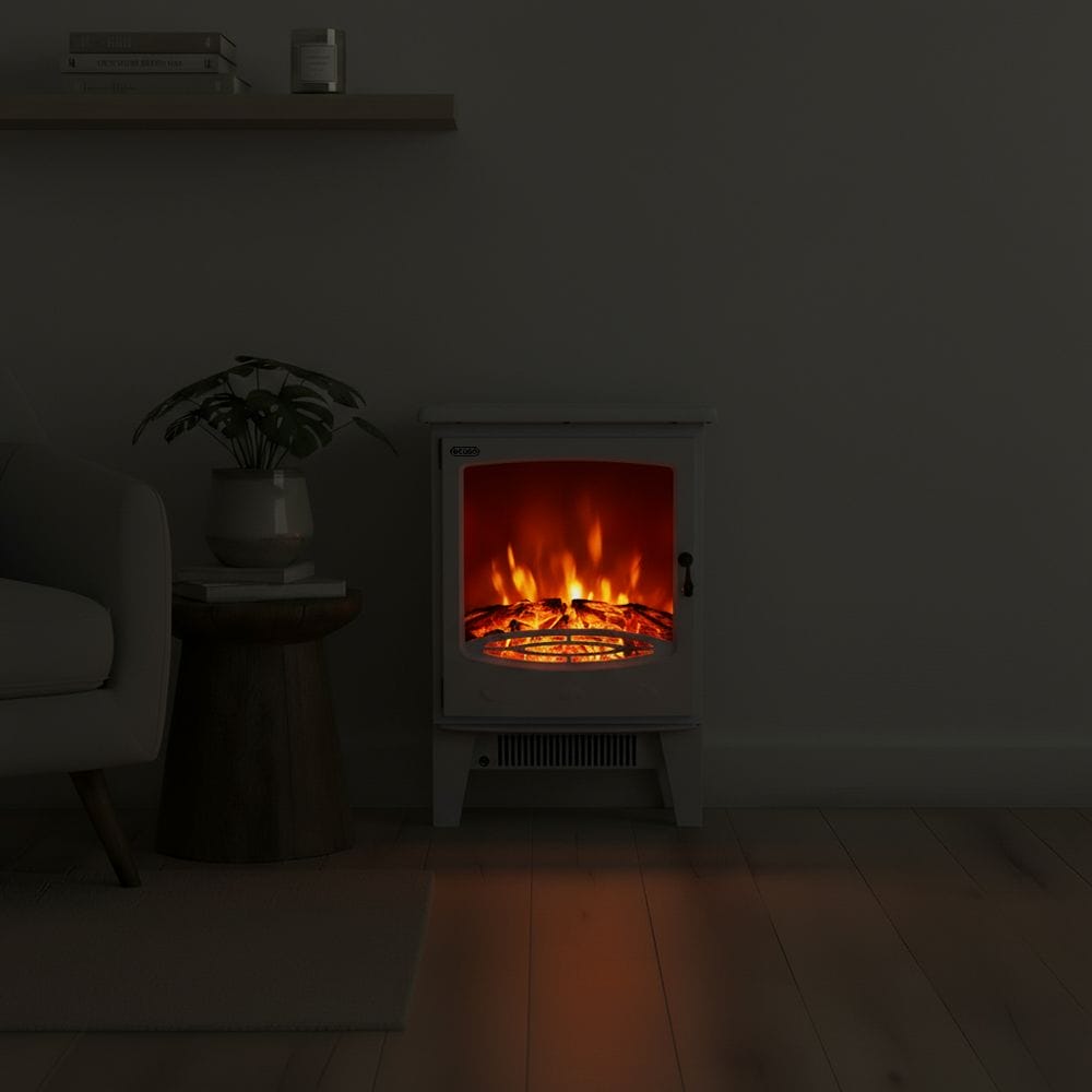 ECOSO Siena white traditional electric stove in dark room nearby houseplant on small table beneath shelf with books and candle
