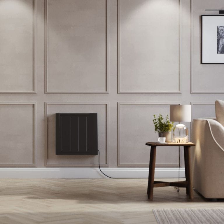 ECOSO Lex black ceramic core smart electric heater on light wall nearby small table and cream chair beneath framed picture