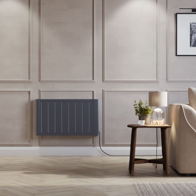 ECOSO Lex anthracite ceramic core smart electric heater on light wall nearby small table with lamp and plant next to cream settee beneath framed picture