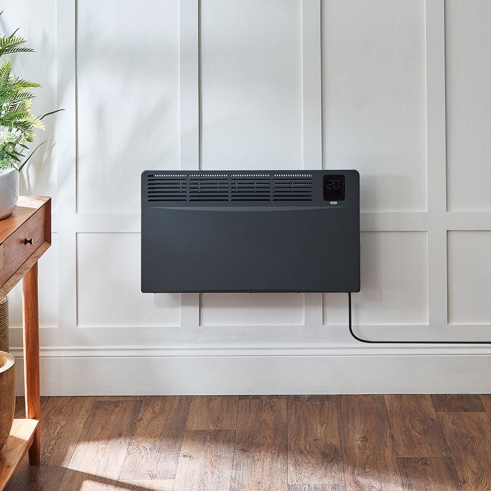 ECOSO Elio black smart electric convector panel plug in heater on white wall above wooden flooring