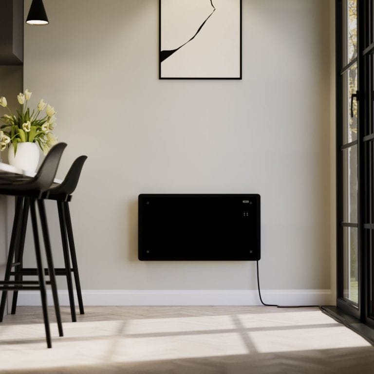 ECOSO Vitrum black smart electric glass panel portable heater on light wall beneath framed art nearby table with vase and black chairs