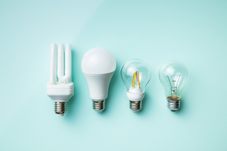 Energy saving and classic light bulbs on colorful background. Top view.