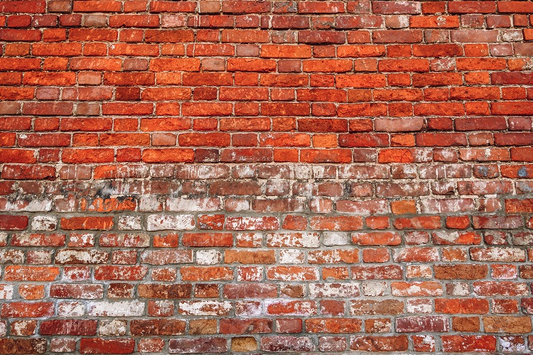 Old chipped wall of red brick. 