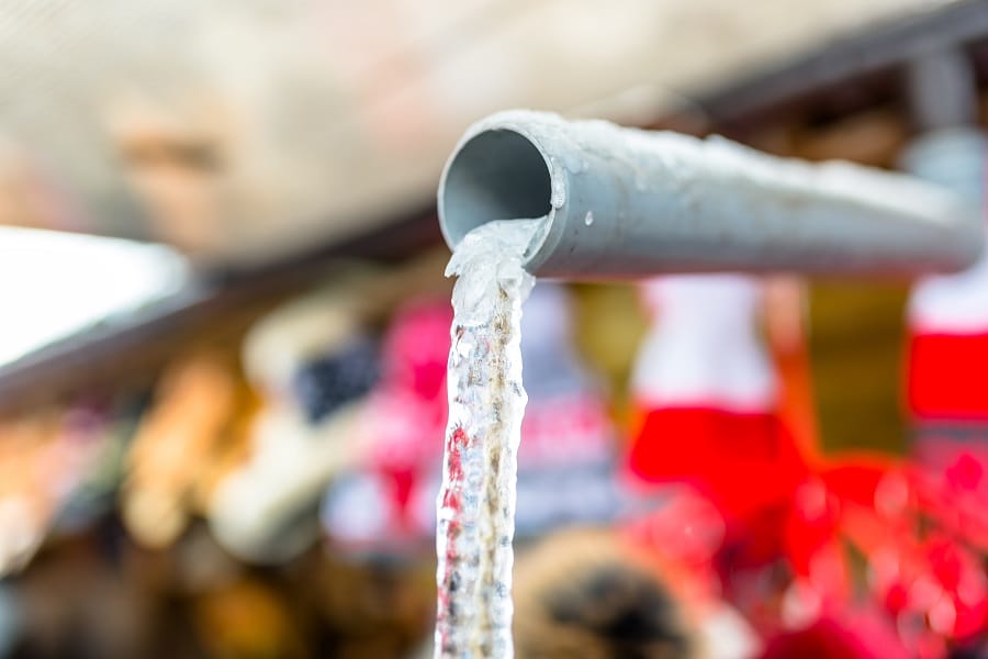Ice dripping from frozen plastic pipe Ice dripping from frozen plastic pipe