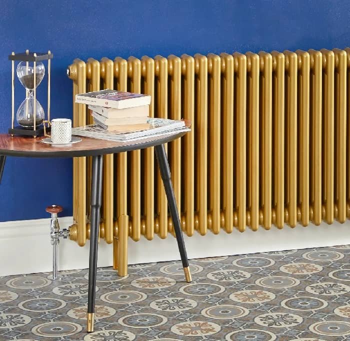 Milano Windsor gold radiator next to a coffee table