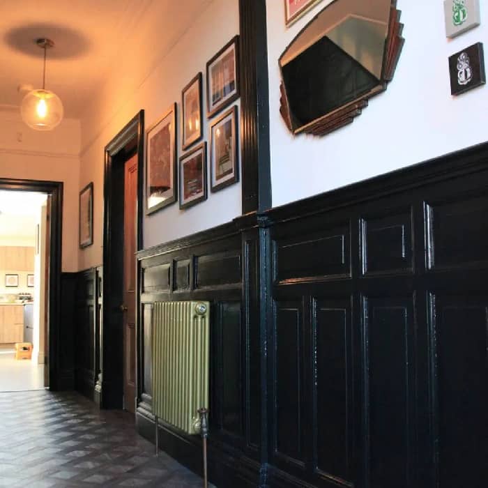 gold column radiator in dark hallway