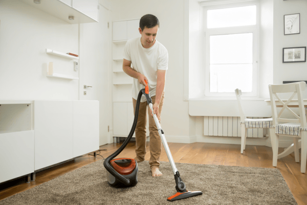 happy man vacuuming