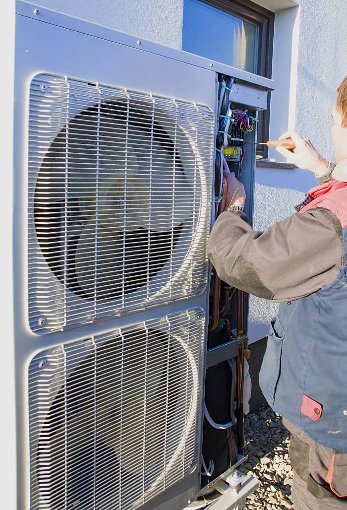 Cast iron column radiator Heat pump being installed at a residential property