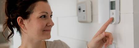 lady turning the heating off