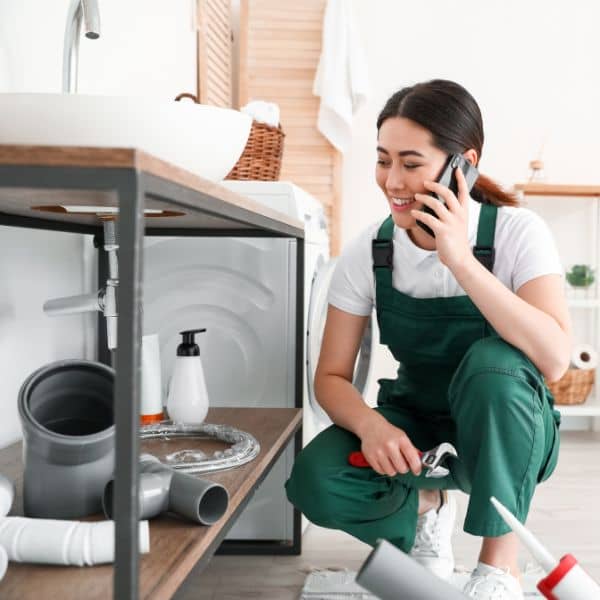 female plumber on the phone to a customer