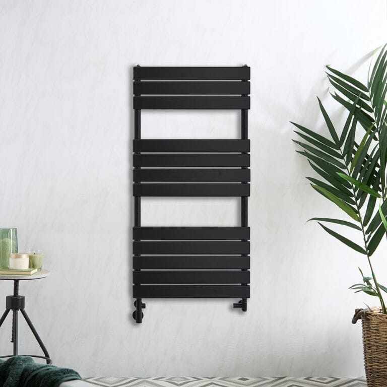 Milano Lustro dual fuel designer black flat panel heated towel rail on white background nearby plant