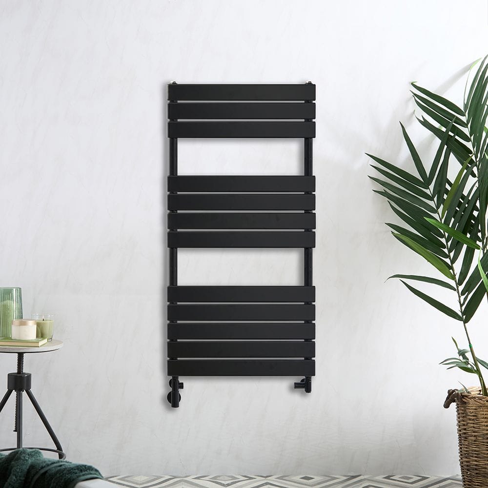 Milano Lustro dual fuel designer black flat panel heated towel rail on white background nearby plant