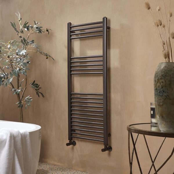 Milano Esk gun metal grey heated towel rail on beige wall in modern bathroom