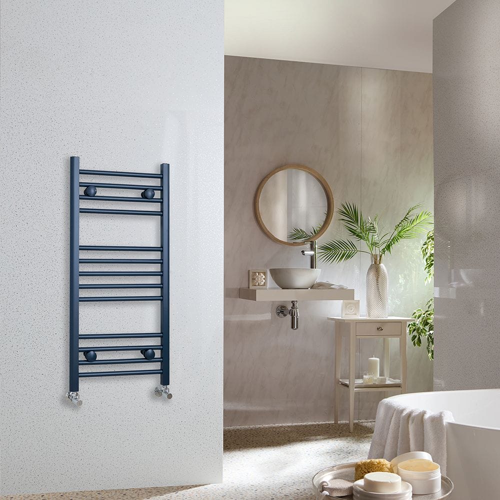 Milano Ive regal blue straight heated towel rail on white wall in modern spa-style bathroom space
