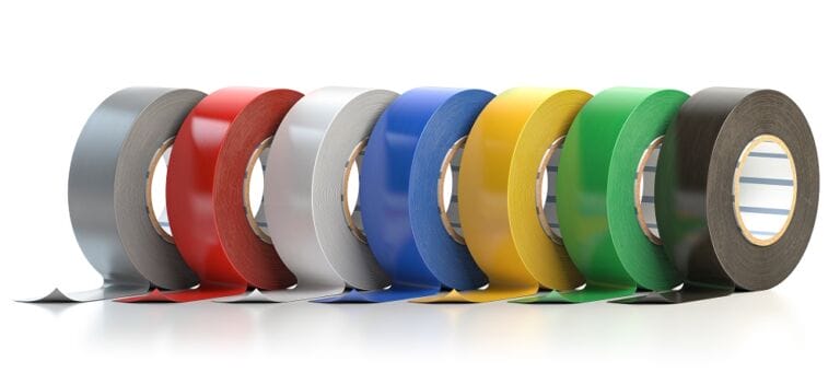 Multiple coloured rolls of insulation adhesive tape or PFTE tape on plane white background