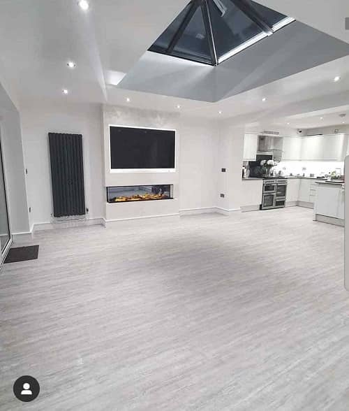 an empty open plan living space with a tall vertical radiator - shot from a different angle of the room