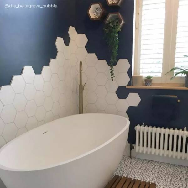 7 Low level white column radiator under bathroom window