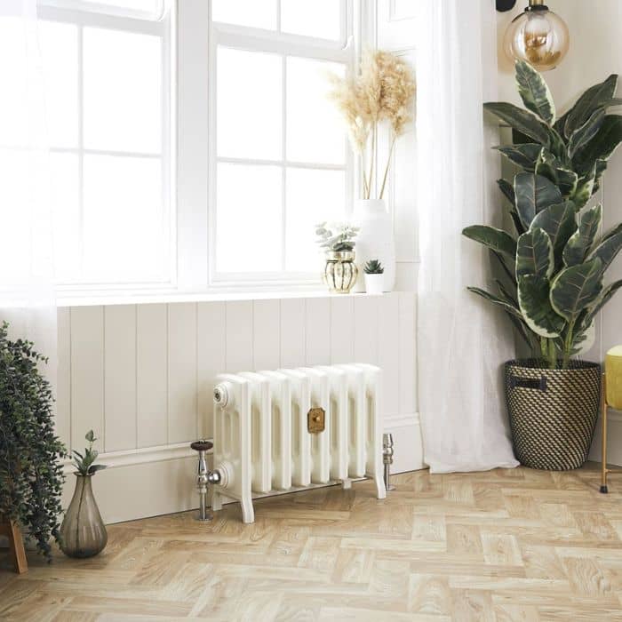 low level cast iron radiator under a window
