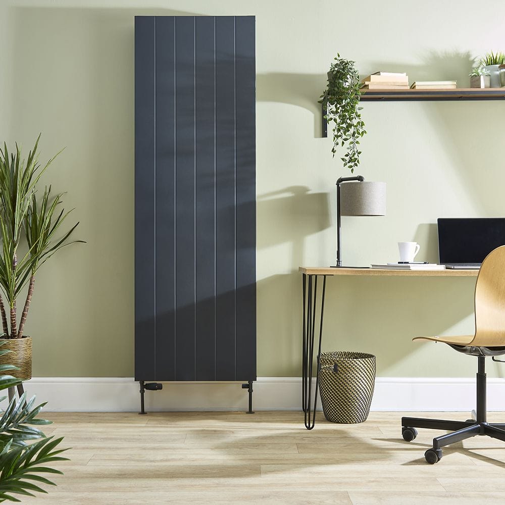 Milano Alora anthracite vertical flat panel type 20 convector radiator on green wall nearby houseplants and shelving