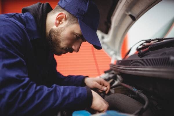 Mechanic fixing the engine of a van