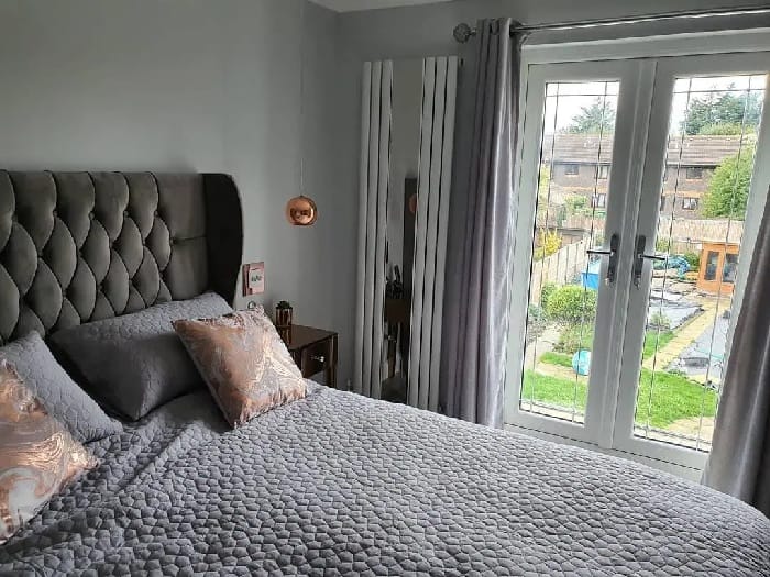 Milano Icon mirrored radiator in a small bedroom Milano Icon mirrored radiator in a small bedroom