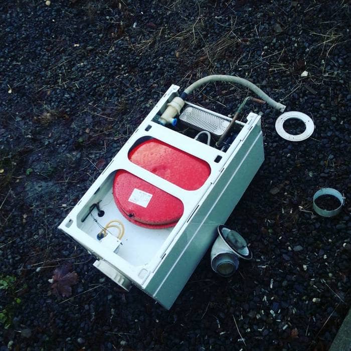 An old boiler lying on the ground after being removed