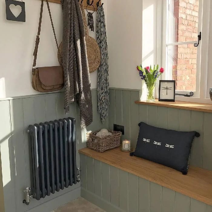 narrow anthracite column radiator in a small boot room
