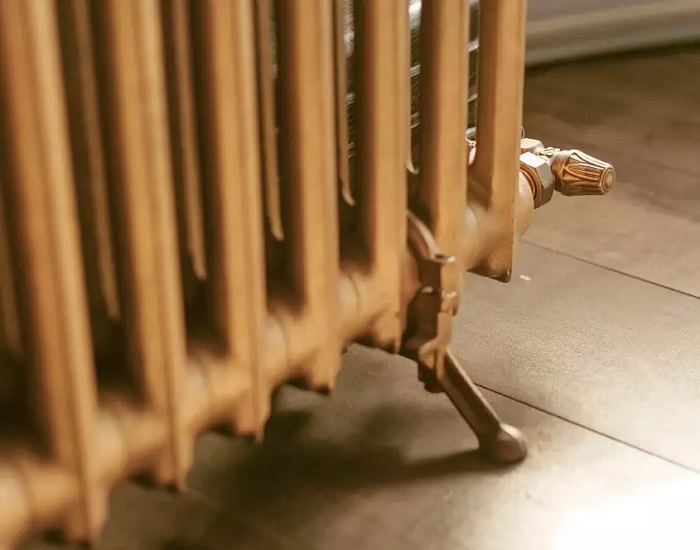 Close up shot of foot of gold cast iron radiator