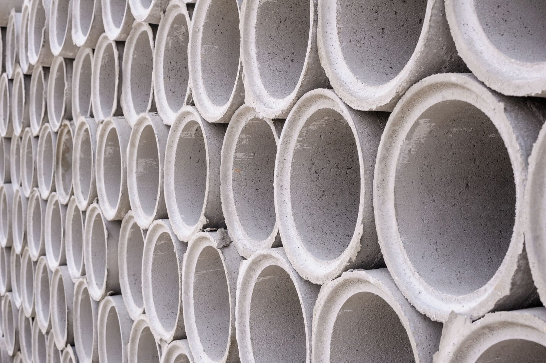 Pile of concrete pipes stacked on top of each other