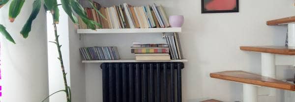 radiator with a bookshelf above it