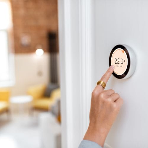 hand using a room wall thermostat