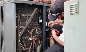service-repair-being-done-on-a-heat-pump-hvac-syst-CUZ5KG7 Service repair on air source heat pump system