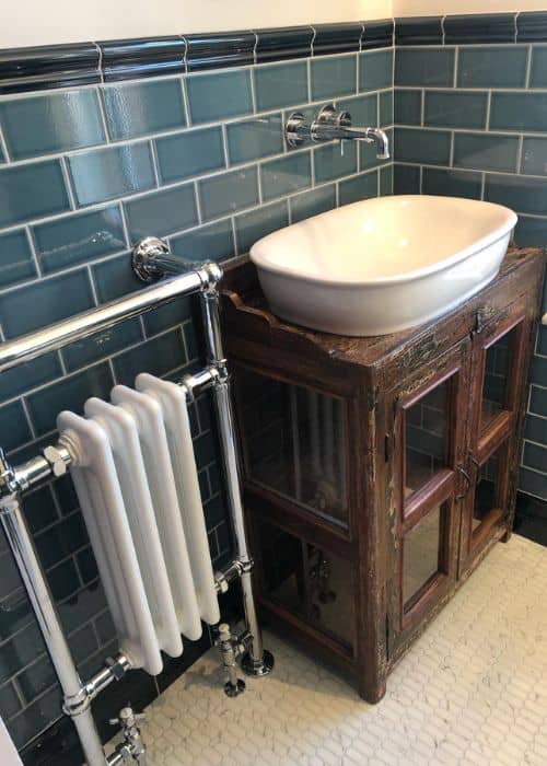 traditional column heated towel rail in a small bathroom