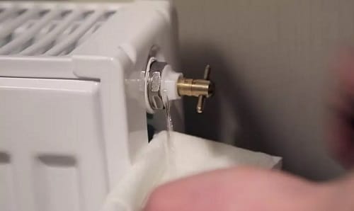 a radiator bleed valve dripping with water