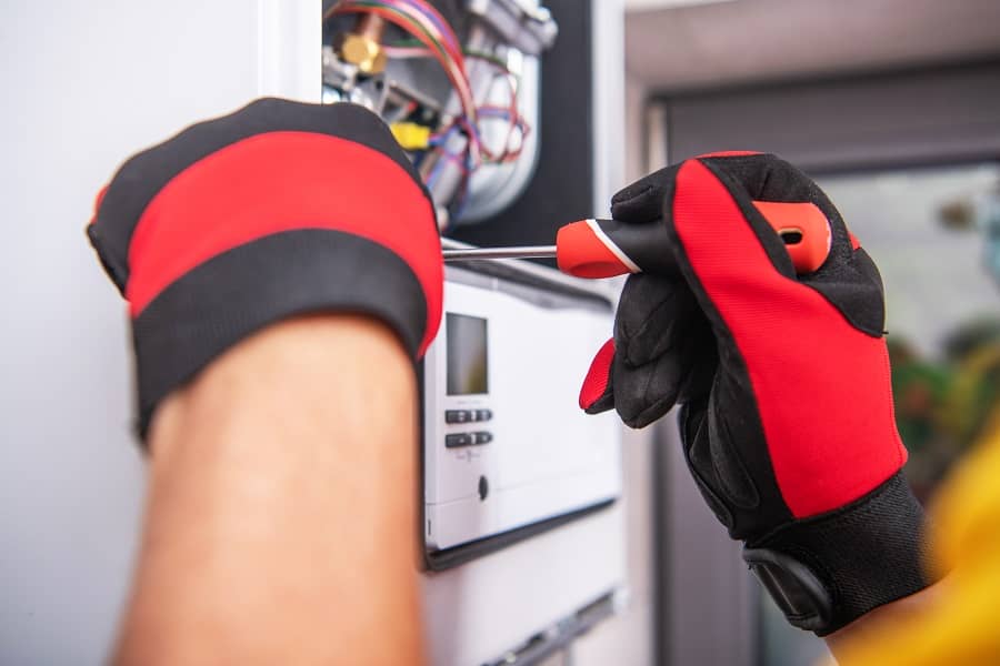 Technician repairing gas heater system device