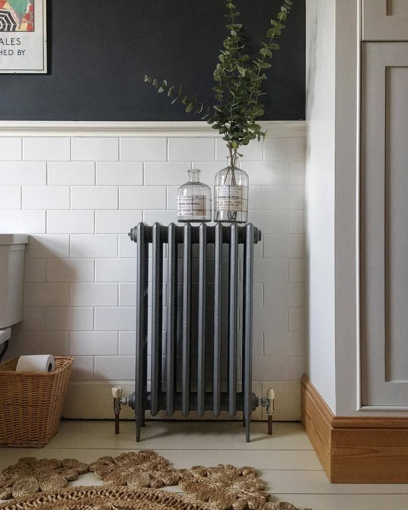 A grey cast-iron radiator on a white wall.