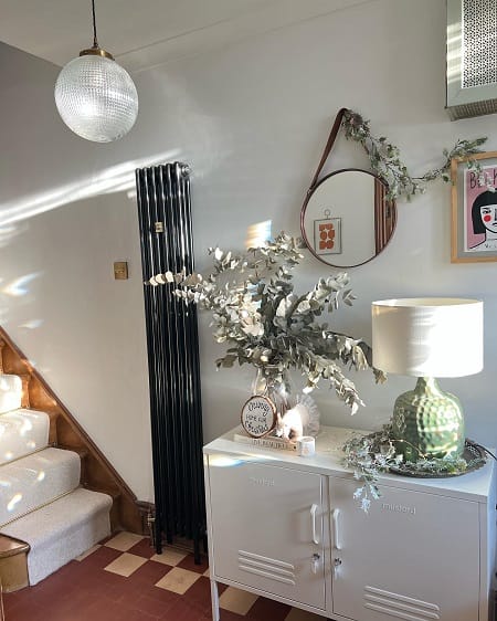 Tall black vertical radiator in hallway area Tall black vertical radiator in hallway area