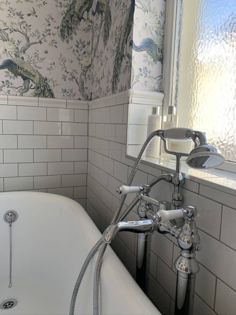 a traditional bath tap next to a bath
