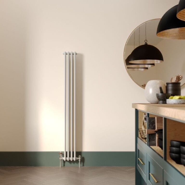 Milano Windsor vertical triple column white traditional cast iron style radiator on cream wall nearby large mirror in modern kitchen