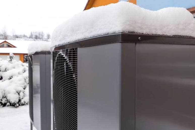 Heat pumps outdoor in winter covered in snow