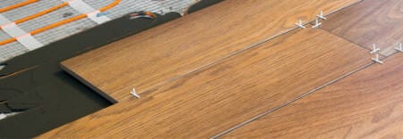 Wooden laminate flooring by electric underfloor heating kit