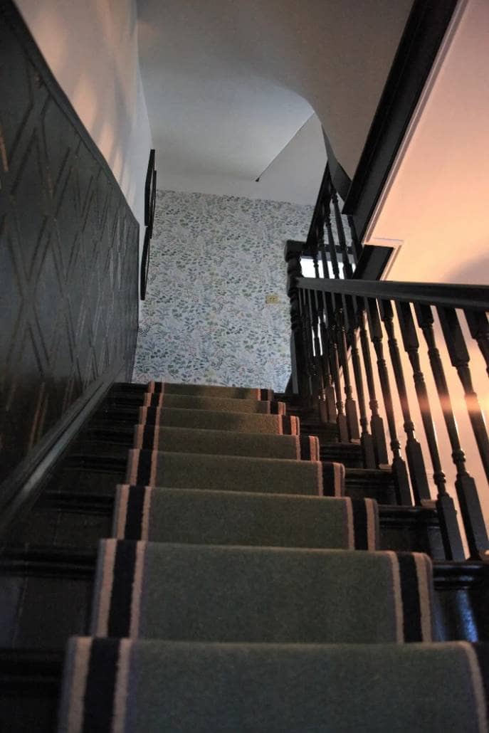 looking up a staircase with a runner carpet